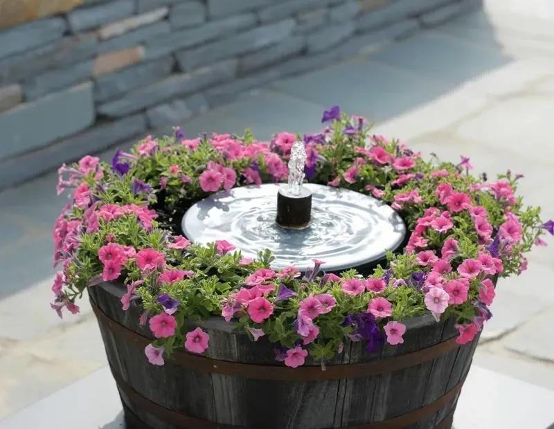 Outdoor Water Feature in a Barrel Planter with Petunias | Relaxing Patio Fountain Idea